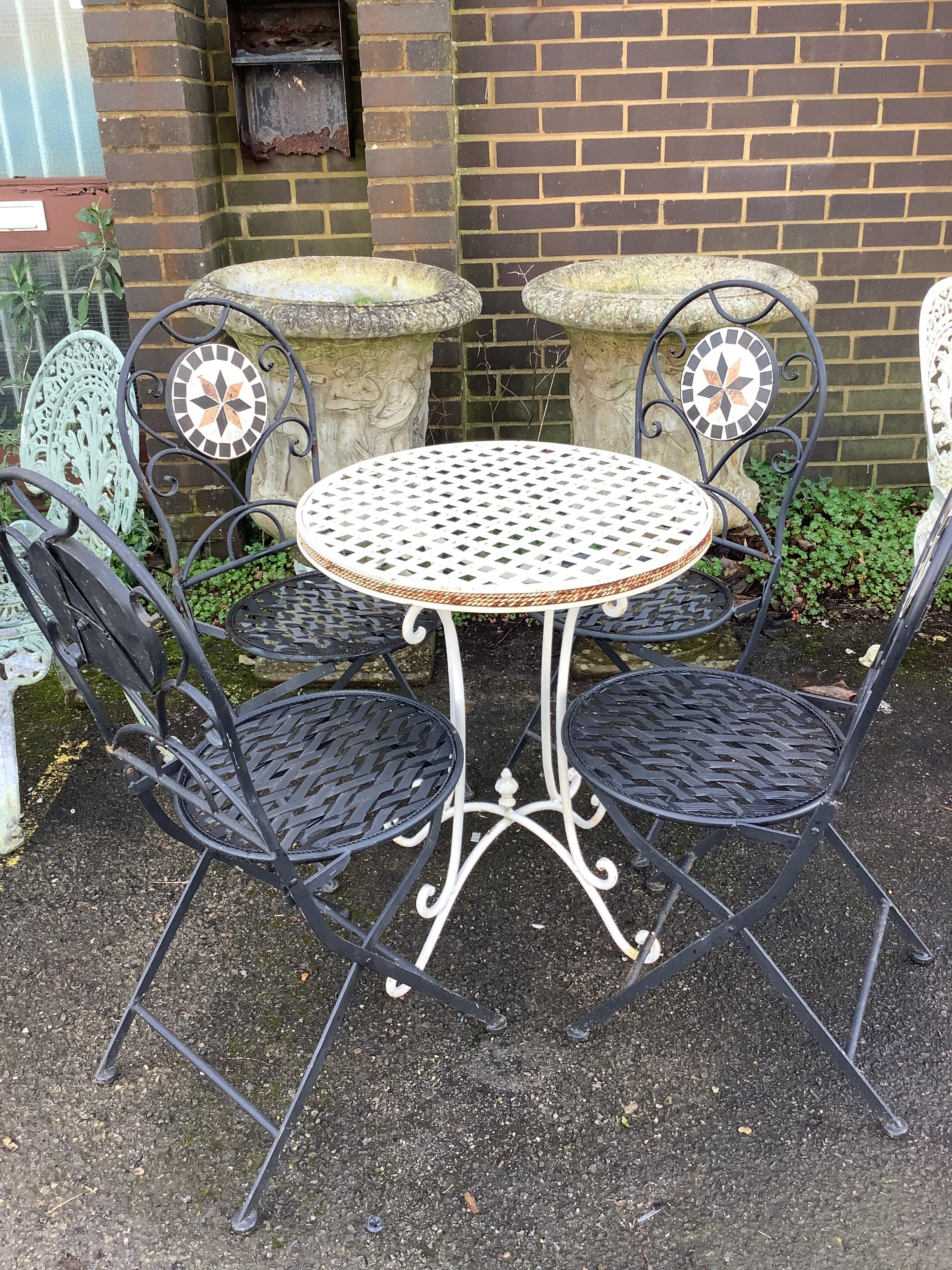 A circular metal garden table, diameter 60cm, height 73cm, together with four mosaic back folding metal garden chairs